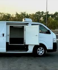 A refrigerated ice delivery van parked outside an event venue in Dubai ready for cold supply drop-off